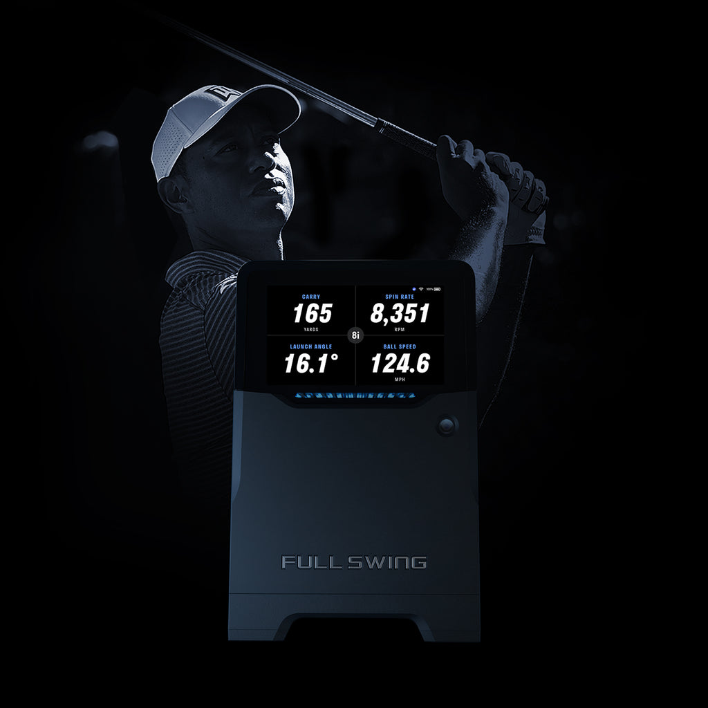 Golfer using a launch monitor with digital display on a black background