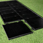 Black plastic mats on grass