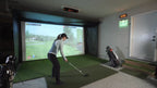 Person using a golf simulator in a home setting