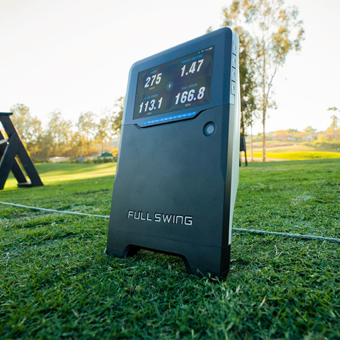 Golf swing analyzer on grass with digital display