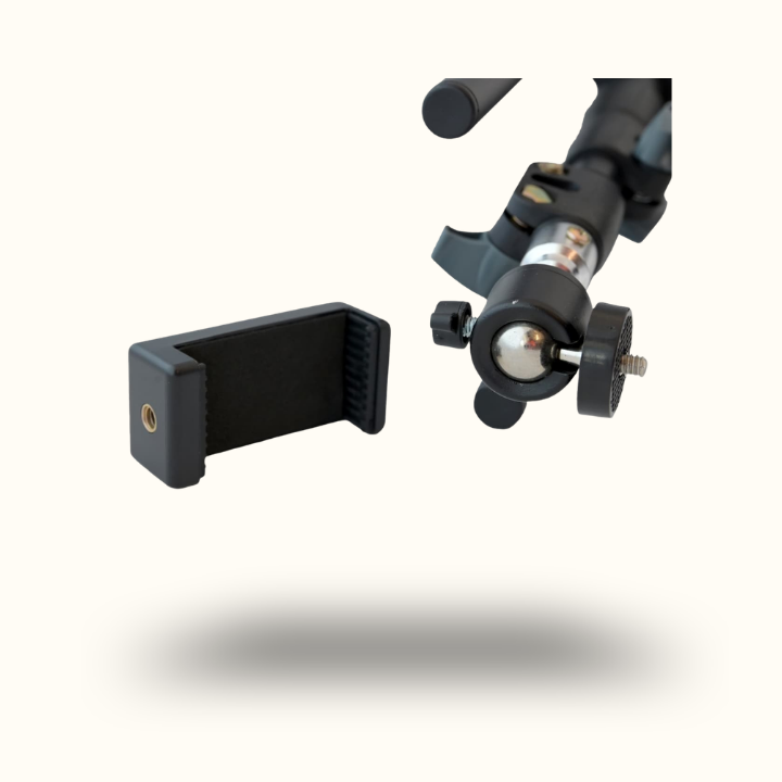 Black camera tripod head and clamp on a white background