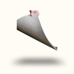 Hand holding a piece of gray fabric against a white background