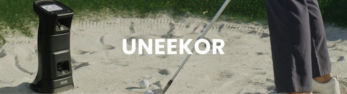 Golf cart and golf club on a sandy surface with 'UNEEEKOR' branding.