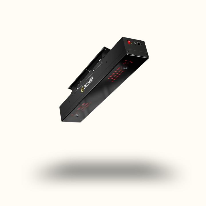 Black rectangular device with red lights on a white background