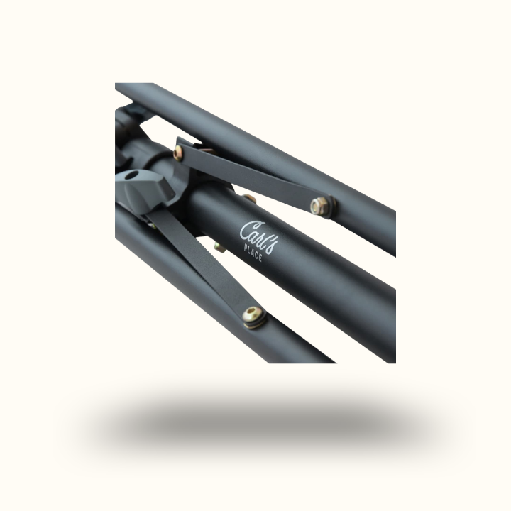 Close-up of a black, metal tripod leg with "Carl's PLACE" branding in white. The sleek, matte finish and bolts suggest durability and quality.