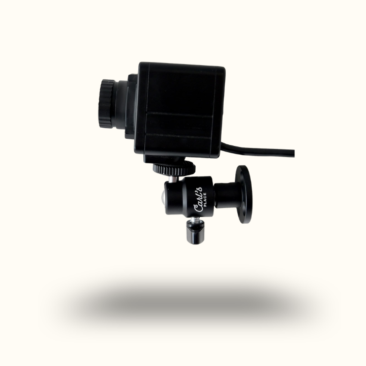 Black camera lens with attached microphone on a white background