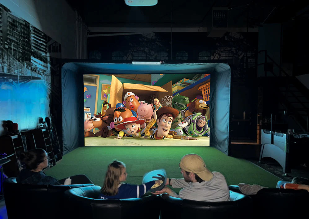 Family watching a movie on a large screen in a dark room