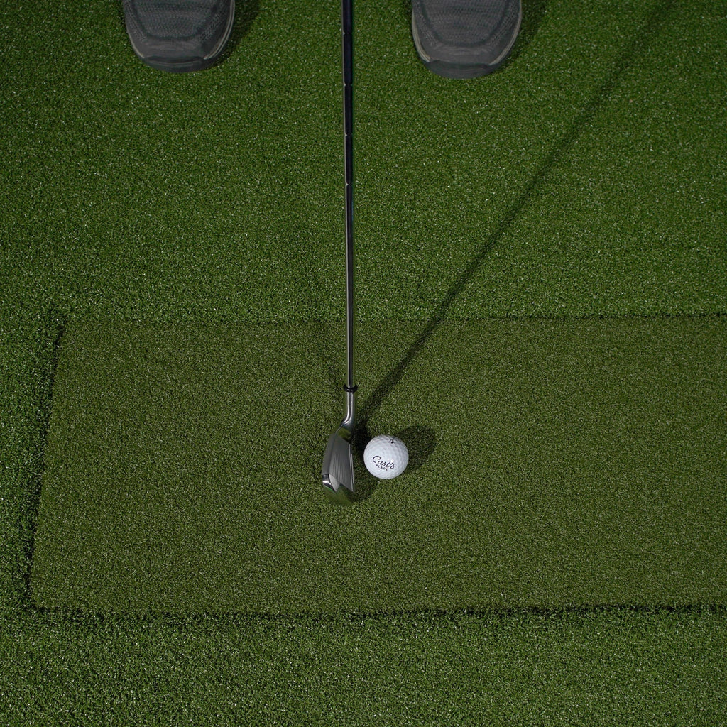 Golf club and ball on a green putting surface