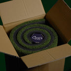 Green roll of carpet with 'Carl's Place' logo in an open cardboard box.