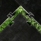 Close-up of a black rubber mat with grass pattern on a tiled floor.