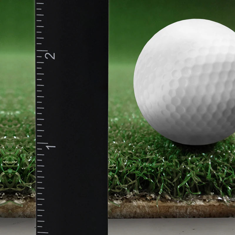 Golf ball on grass with a ruler for scale